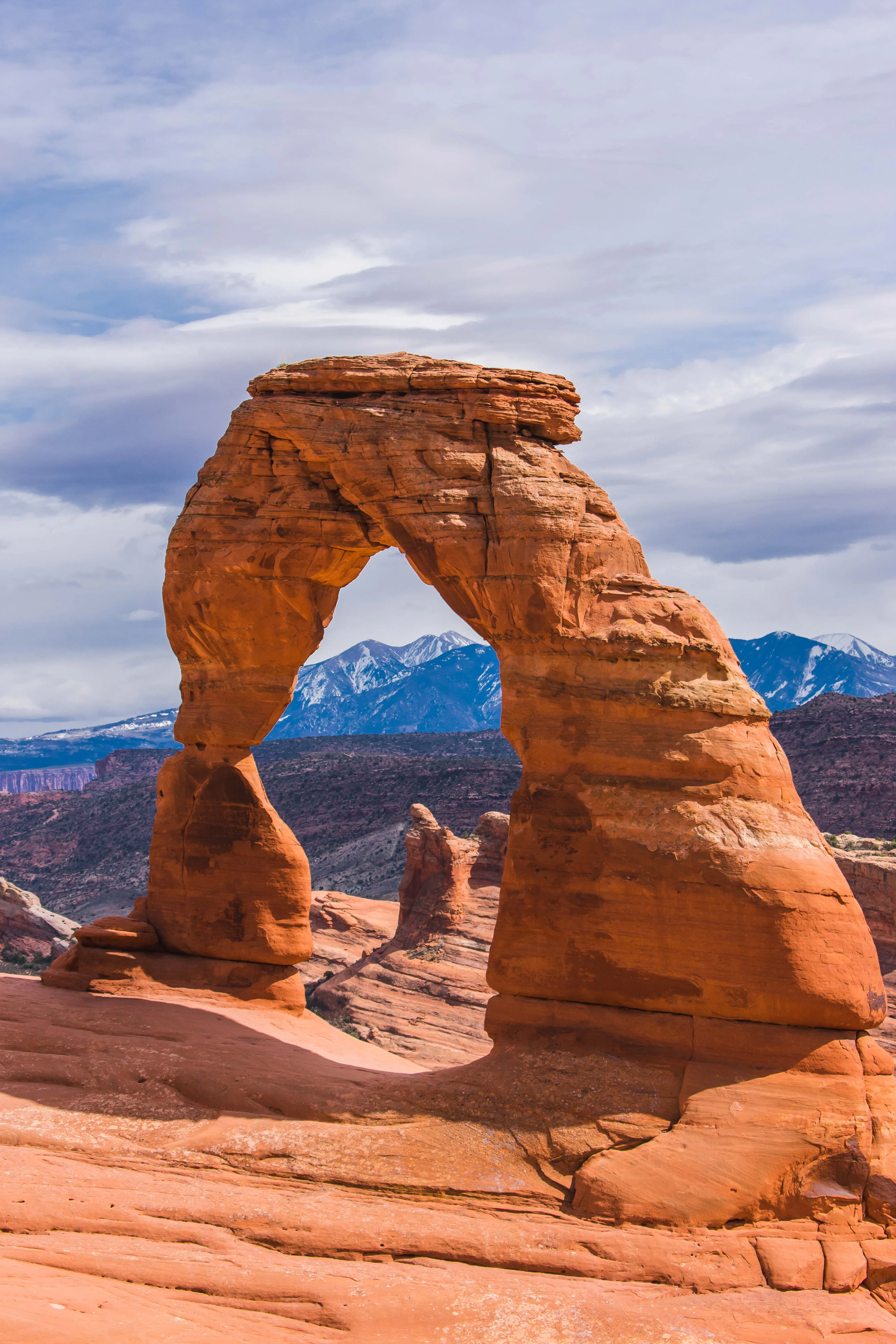 Thomas McClure Landscape Photography of natural sandstone arch framing the high desert in Arches National Park Utah