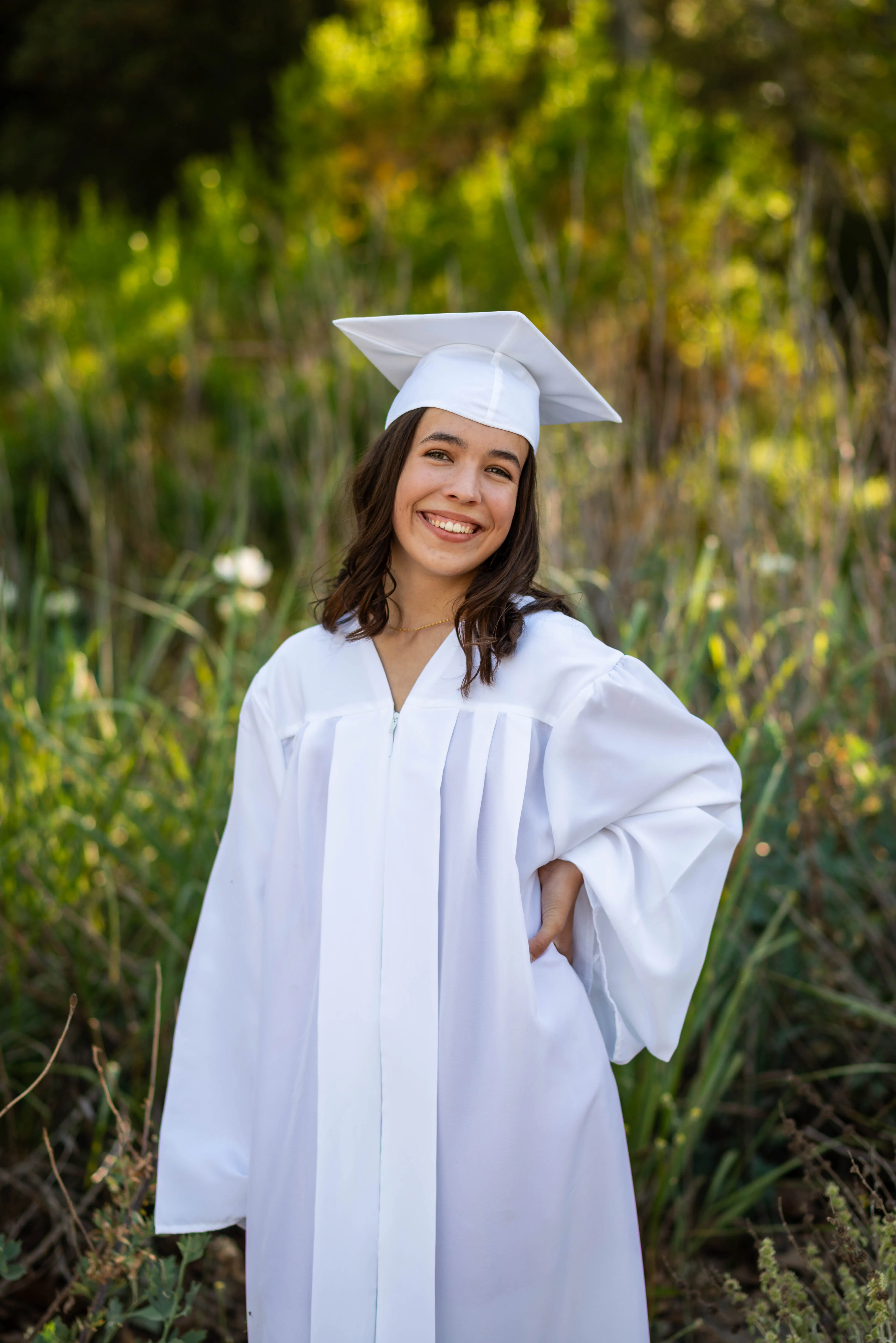 Candid lifestyle portrait photography by Thomas McClure of a woman walking in a sunlit field in California
