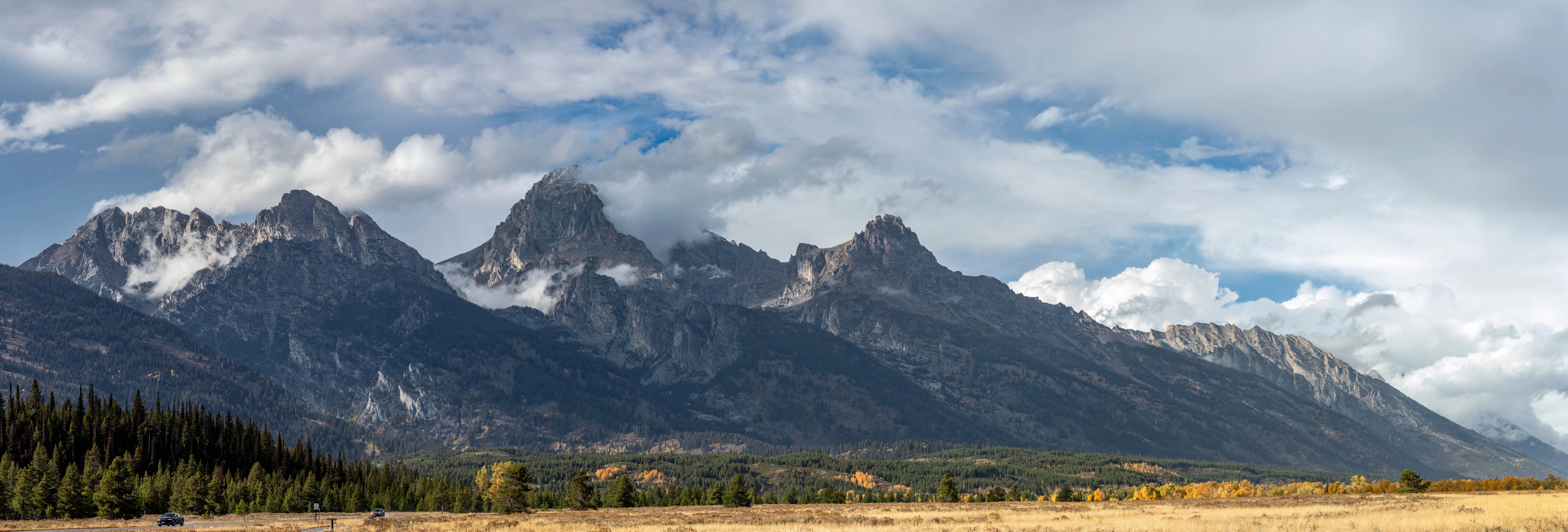 Panoramic landscape photography by Thomas McClure of Grand Teton mountains illuminated by pink alpenglow at sunset